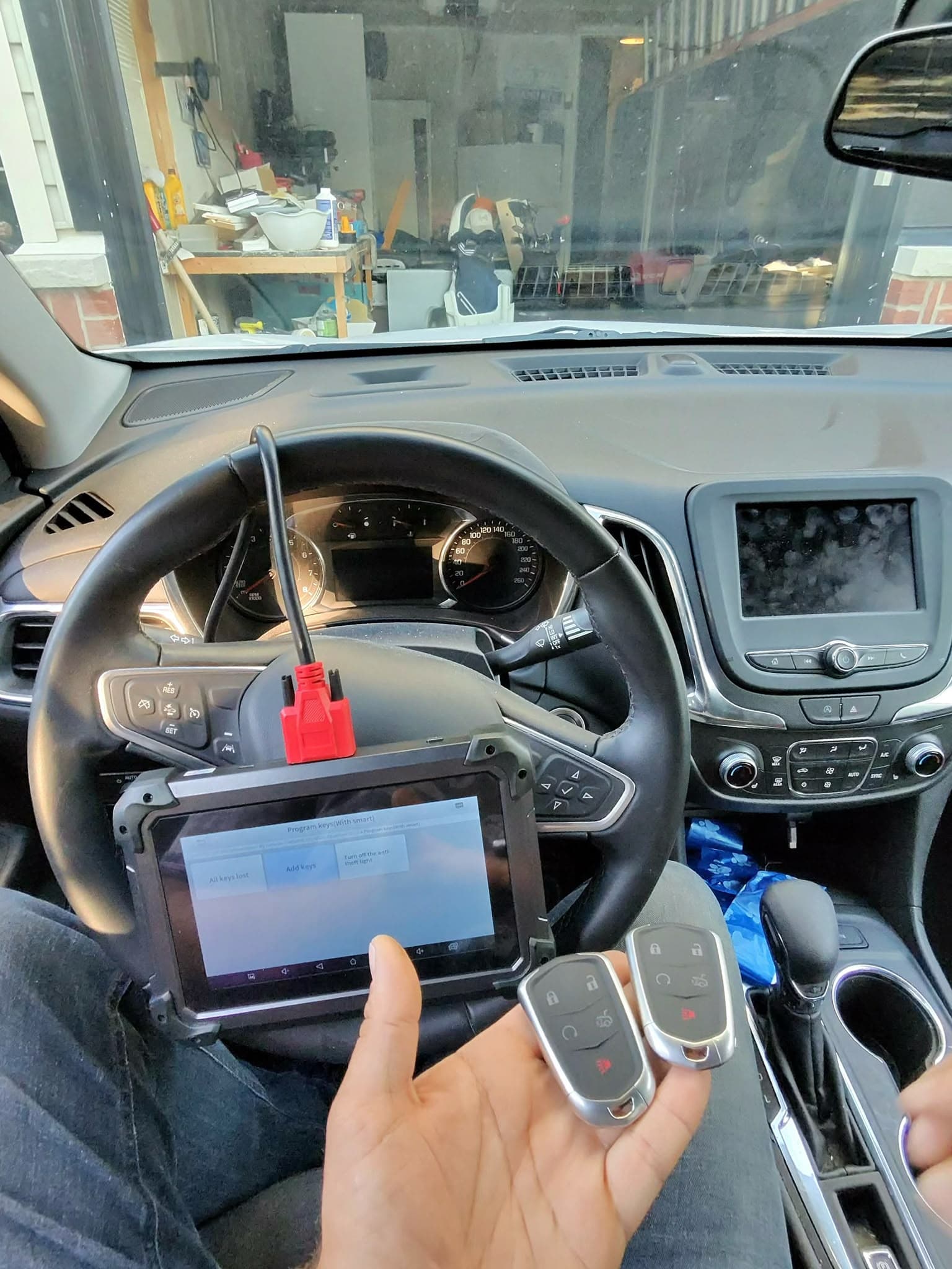 Programming tablet showing the key menu beside the two finished keys