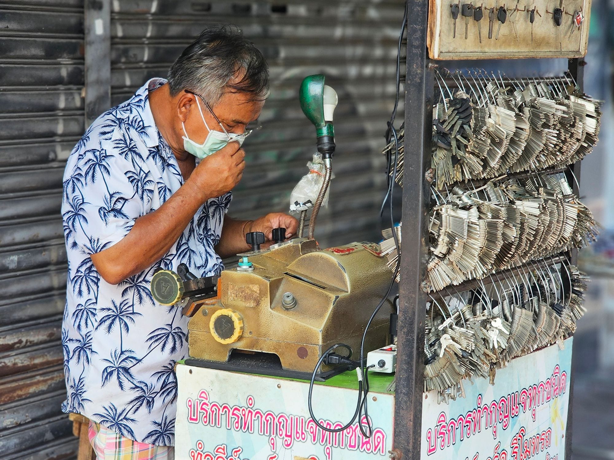 A mobile locksmith cutting a key on a portable machine